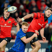 Alex Nankivell, of Munster Rugby, is tackled by Ciarán Frawley, of Leinster Rugby, during the URC derby fixture at Thomond Park on Saturday evening