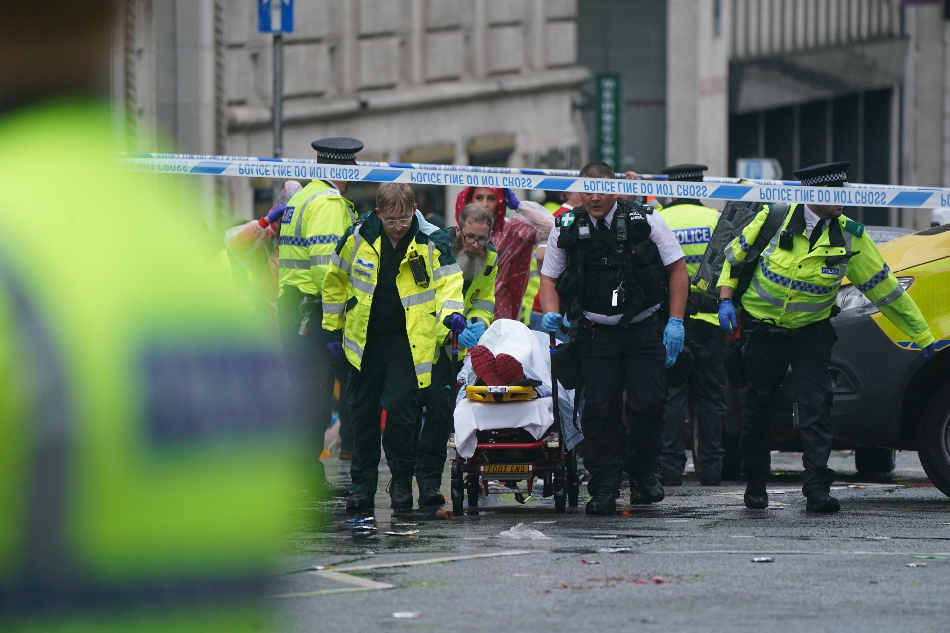 Paramedics take one of the injured fans from the scene PIC: PA