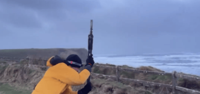 Pictured: A member of Weather and Radar UK/Ireland's team braving the Cliffs of Moher in the midst of Storm Éowyn.