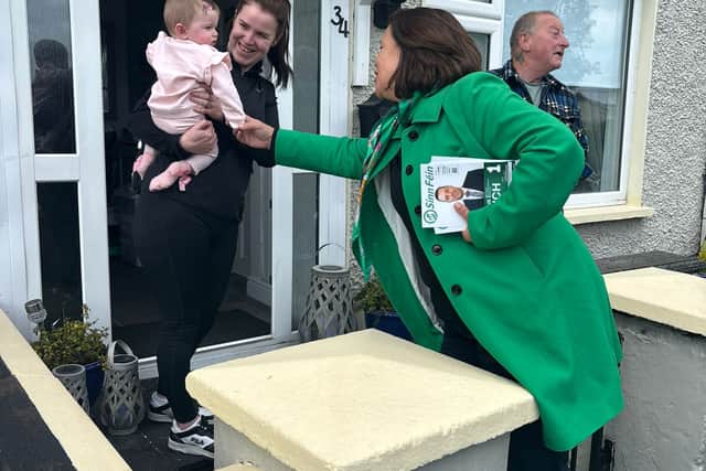 Flanked by two local election candidates, Ms McDonald chats to the householders about their dog and baby Alex Rose, who is aged eight months.