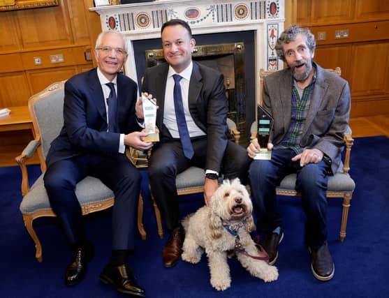 An Taoiseach presented Paul Allen, Charlie Bird, and his dog Tiger with the award