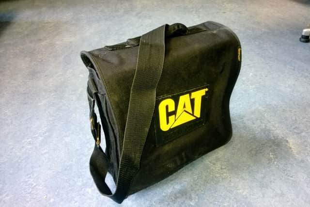 She was carrying a distinctive black satchel-type bag with long shoulder straps and the word “CAT” in large yellow capital letters on the side. The black satchel bag has never been located.
