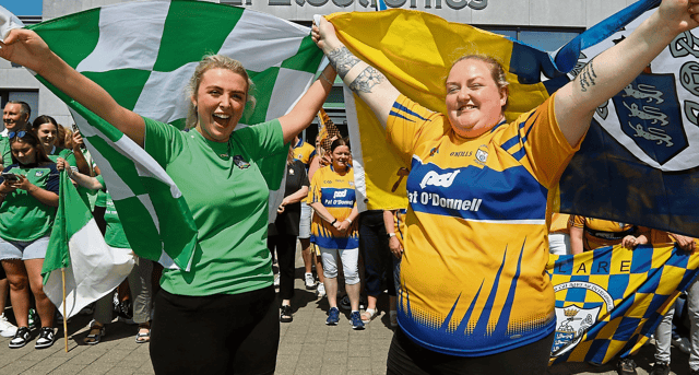 Katelyn Fitzgerald and Michelle Canny showing their support for Limerick and Clare, respectively, at EI Electronics in Shannon ahead of Sunday's Munster final | PICTURE: Brendan Gleeson