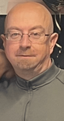 Thomas is described as being approximately 5 foot 2 inches in height and of a medium build. He is bald and has blue eyes.