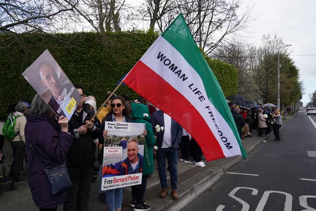 People who attended the protest outside the Iranian embassy held flowers, signs and the Women, Life Freedom sign of the feminist movement in Iran.