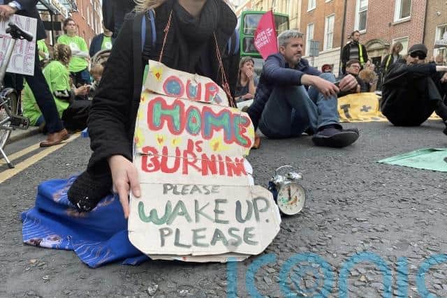 The words “fossil fuel RIP” were spray-painted on the pillars at the gates of Leinster House, and the crowd chanted “system change not climate change” as they moved outside the gates.
