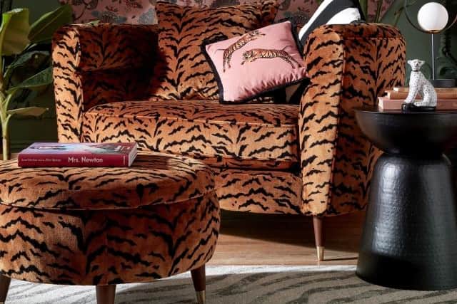 8. The Sofology Offbeat Chesterfield in Offbeat Tiger Print All Over Loveseat, £1899, and Storage Foot Stool, £599, Sofology
