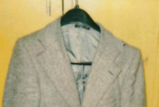 When discovered, he was wearing a grey Herringbone Tweed jacket with a ‘Taldy Madrid’ label, a white ‘Luigi Rossi’ shirt, a red vest, grey trousers (size 34) with a ‘C&A’ label, and black leather zip up boots (size 8).