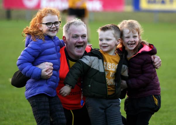 Eugene Organ celebrates with his children at the end of the Donegal SHC final. Photo: Thomas Gallagher