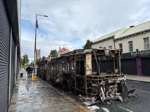 A burned-out Glider bus on Newtownards Road in east Belfast after anti-immigration violence