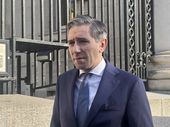 Head and shoulders photo of Simon Harris speaking outside