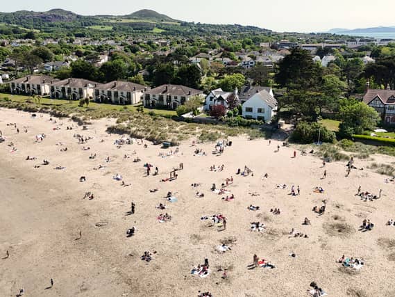 Sunbathers soak up the sunshine at Burrow Beach in Dublin