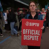 Sinead McCarville, senior housekeeper in the high dependency unit at the Mater Hospital, Dublin, takes part in a 24-hour strike outside the hospital over delays in agreeing a new public sector pay deal