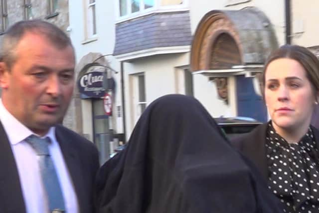 A woman (centre) arriving for a special sitting at Clonmel District Court (Jonathan McCambridge/PA)