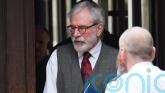 Gerry Adams arrives at High Court for bombings trial