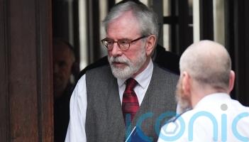 Gerry Adams arrives at High Court for bombings trial